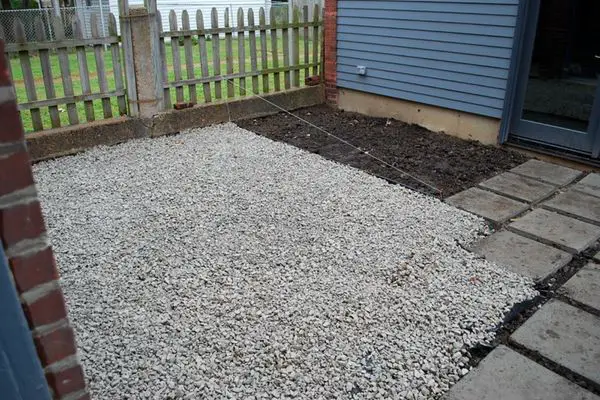 Spreading gravel in the backyard
