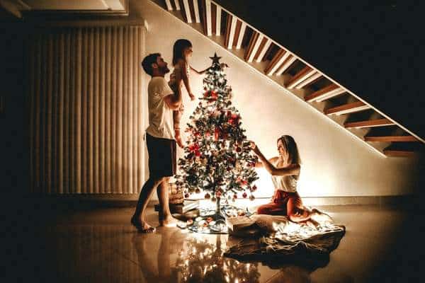 Happy family decorating a christmas tree