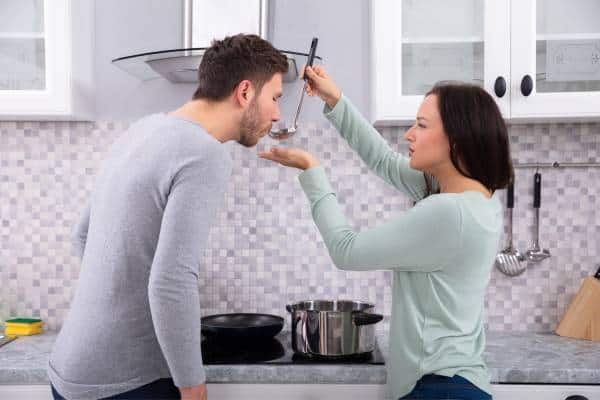 Husband and wife tasting food