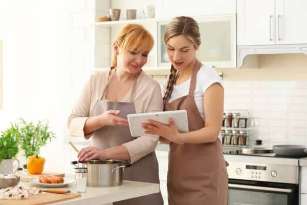 Mom and daughter cooking together